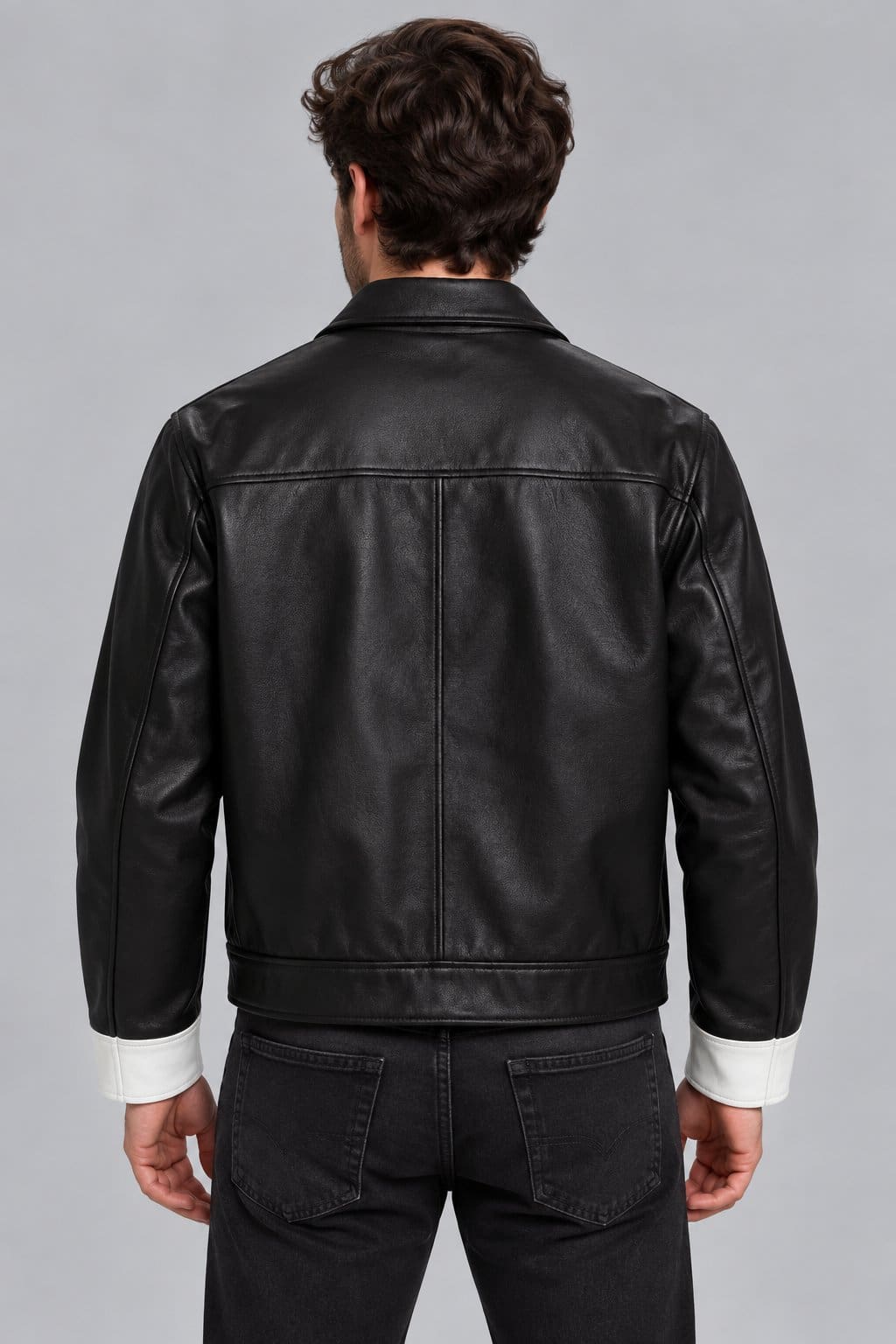 Men’s black and white lambskin leather color block biker jacket back view with bold color block design and clean leather finish