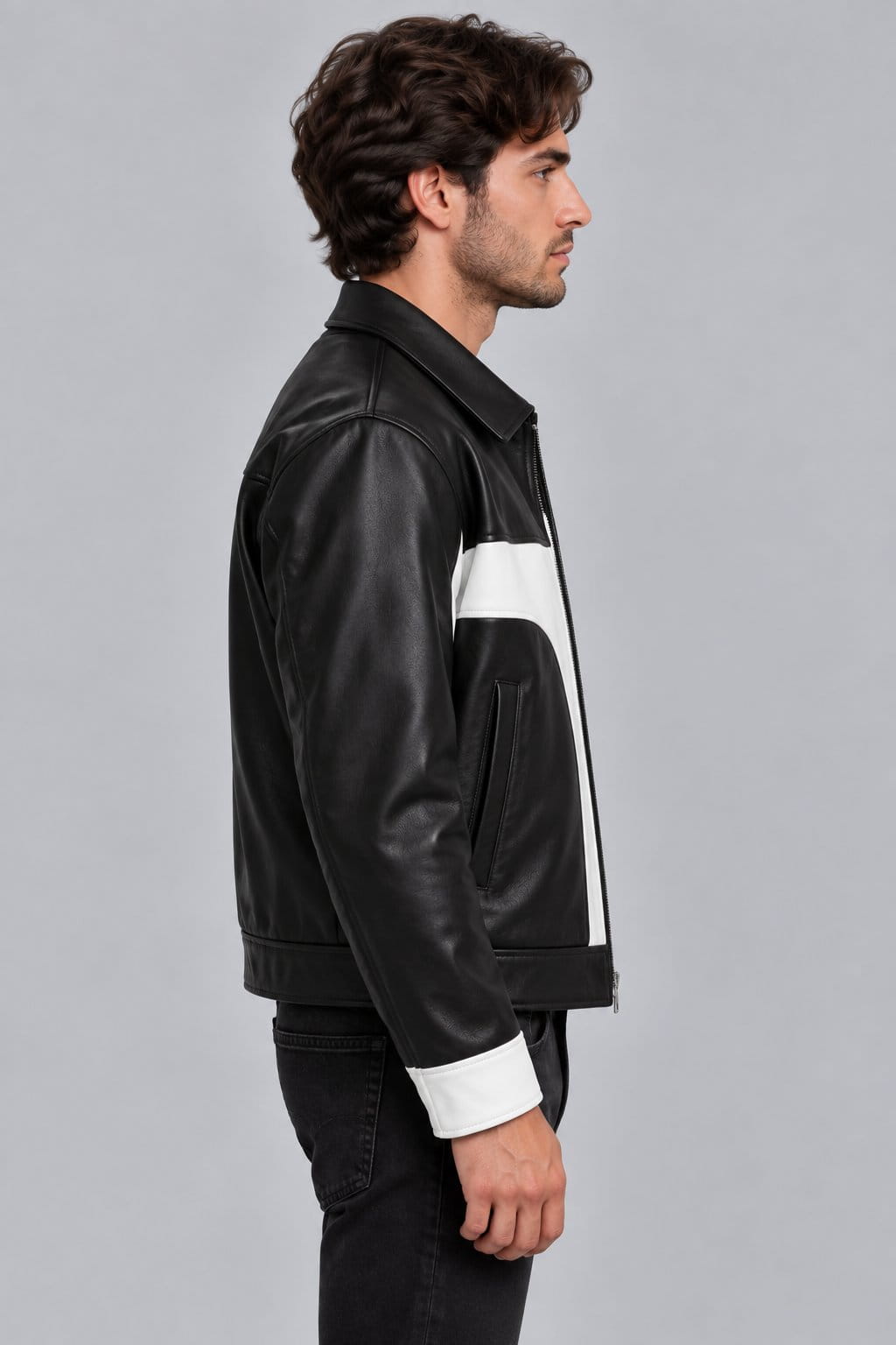 Men’s black and white lambskin leather color block biker jacket side view showing fitted silhouette, contrasting leather panels and long sleeves