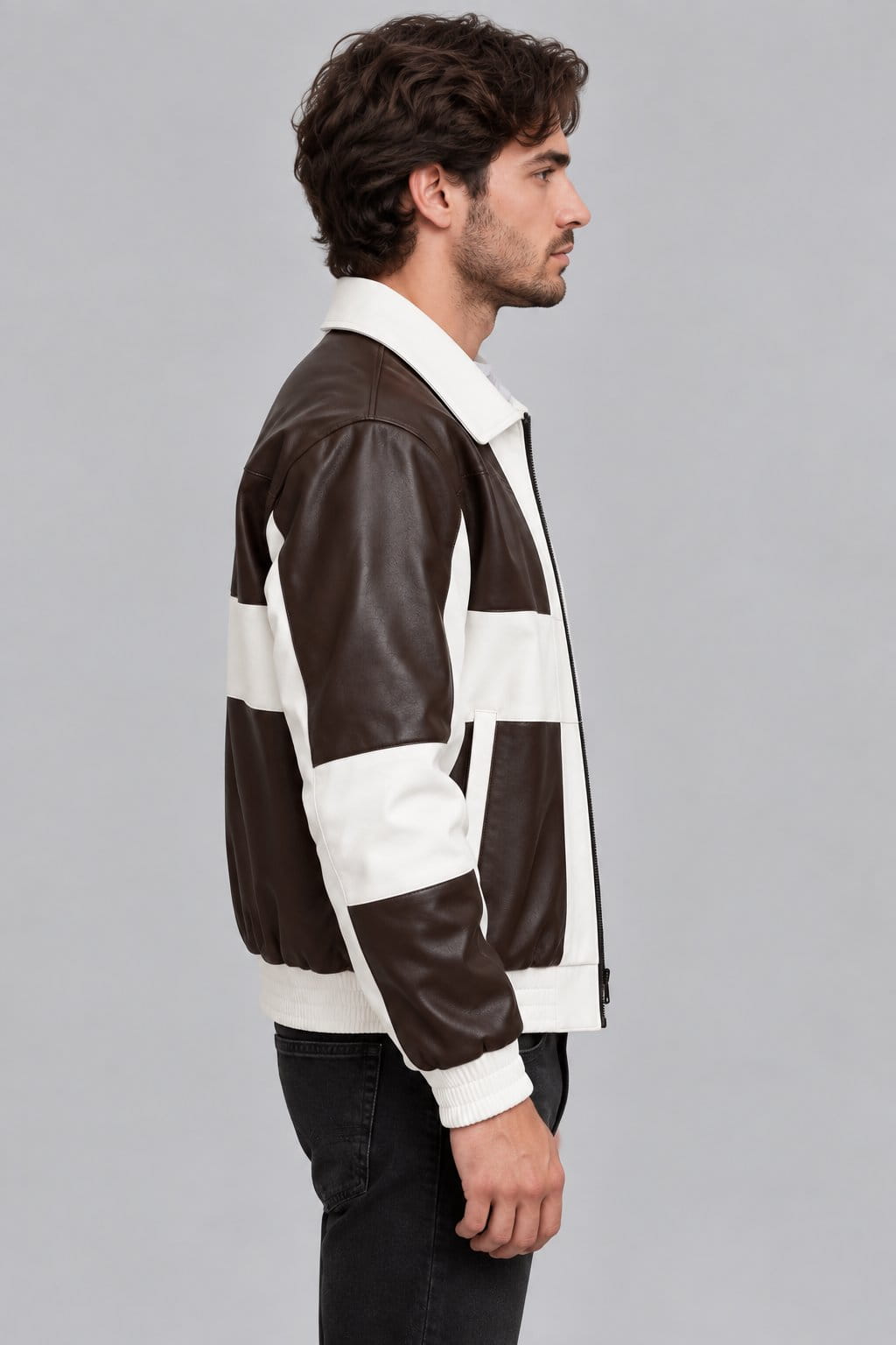 Men’s brown and cream genuine lambskin leather bomber jacket side view showing structured fit, contrasting leather panels and ribbed cuffs