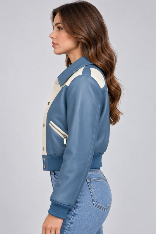 Women’s dusty blue and cream lambskin leather color block bomber jacket side view showing tailored fit, contrasting leather panels and ribbed cuffs
