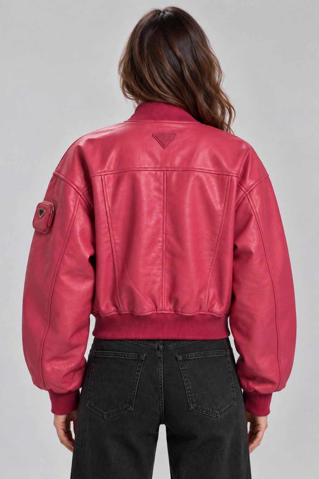 Women’s pink genuine leather oversized bomber jacket back view with clean leather finish, relaxed fit and ribbed hem