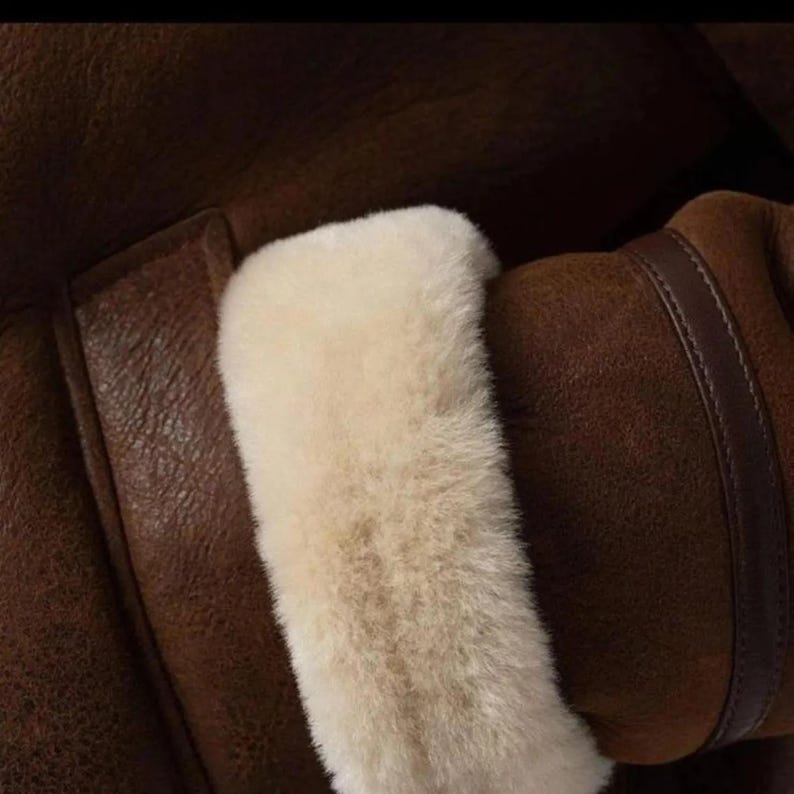 Close-up of shearling cuff on brown leather jacket