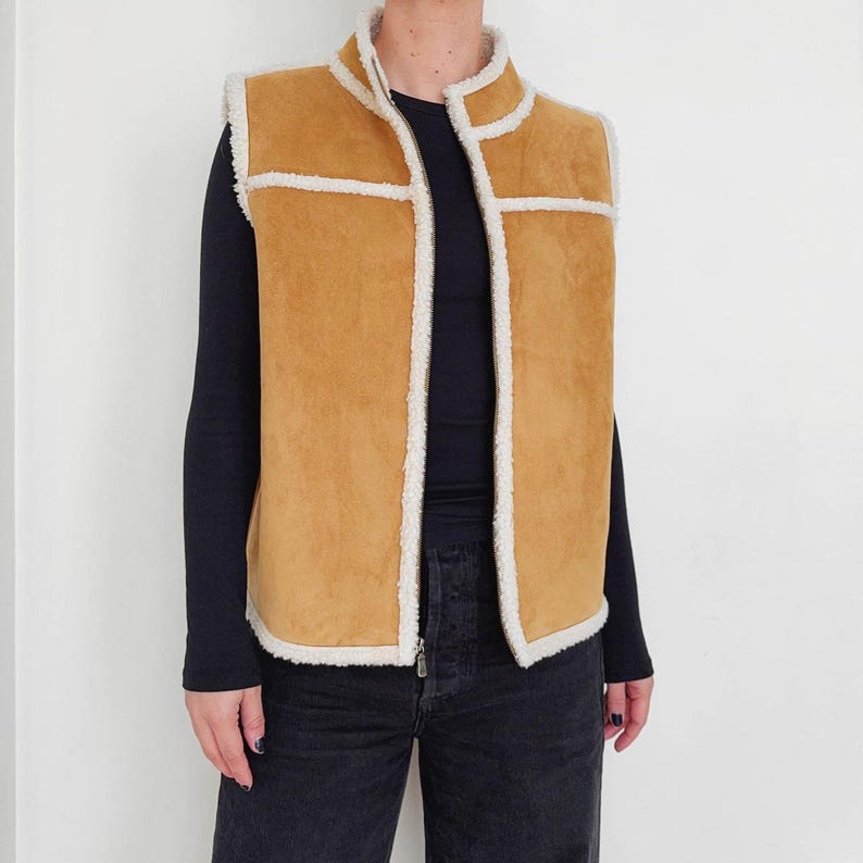 Cream shearling lining inside women's tan suede vest