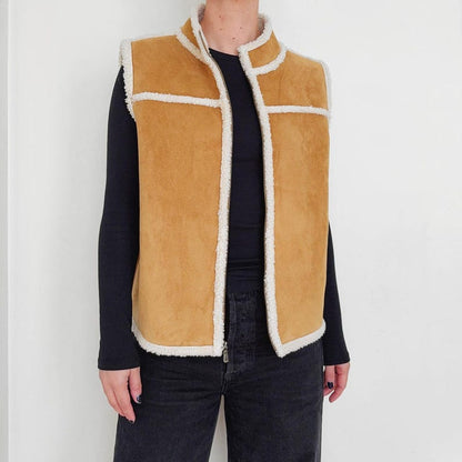 Cream shearling lining inside women's tan suede vest