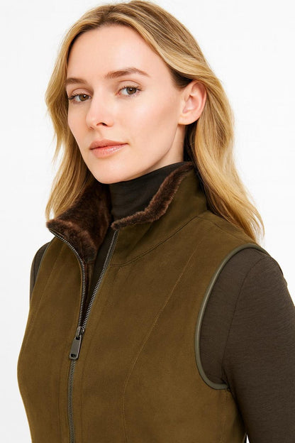 Olive faux suede gilet with full zip worn over a green turtleneck