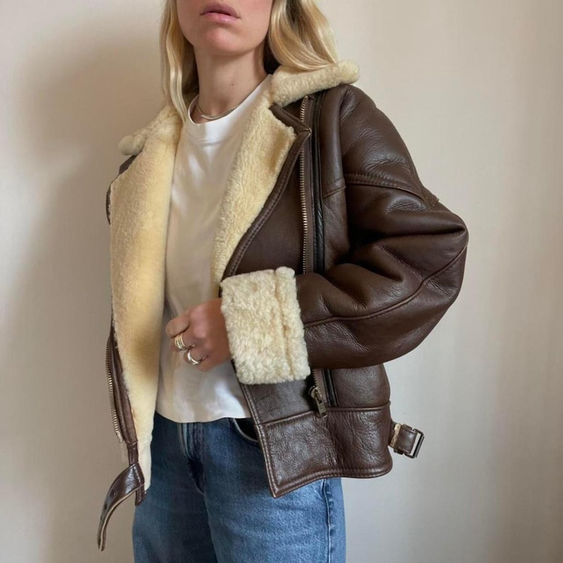 Buckled belt and shearling collar on brown jacket
