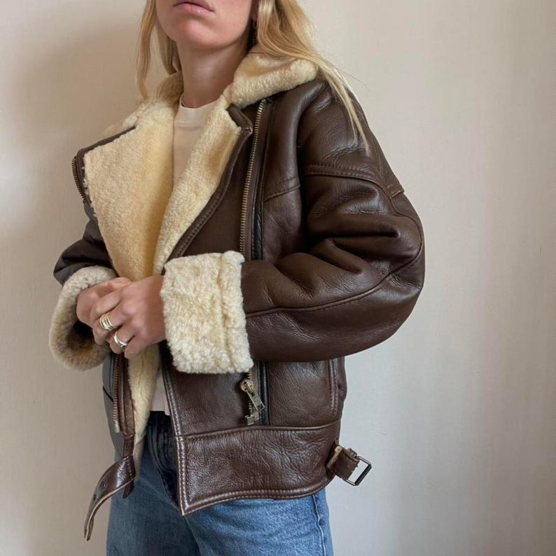 Women's brown sheepskin aviator jacket worn with jeans