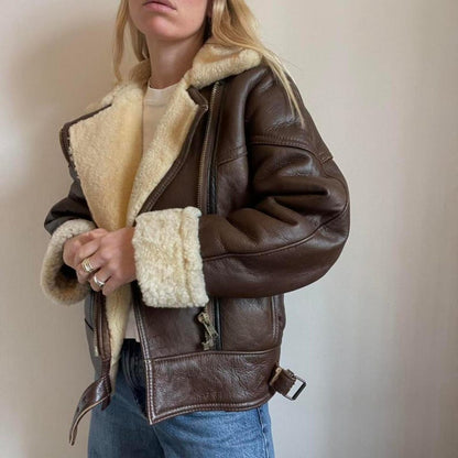 Women's brown sheepskin aviator jacket worn with jeans