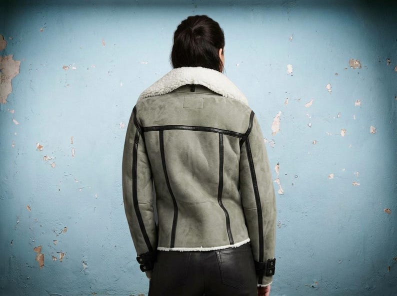 Back view of gray suede biker jacket with white faux fur collar
