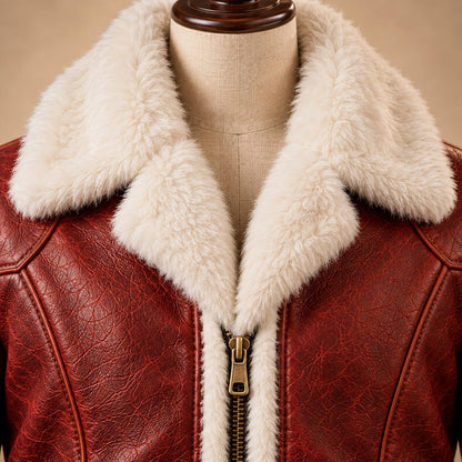 Close-up of distressed red leather and bronze zipper pull