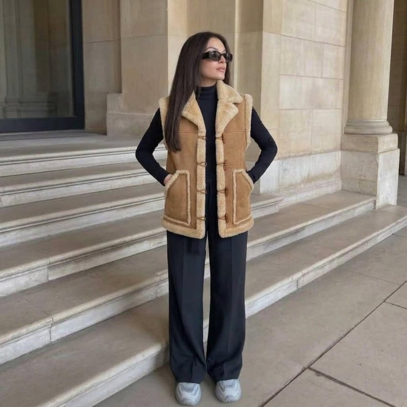 Wooden toggle closures on women's beige suede vest
