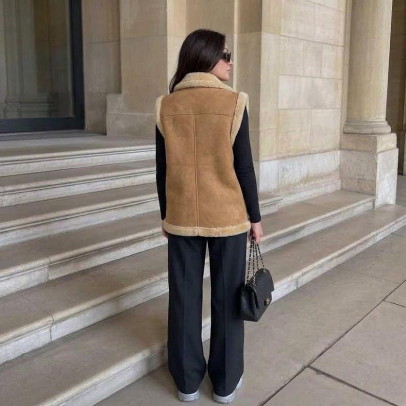 Back view of women's beige suede shearling vest