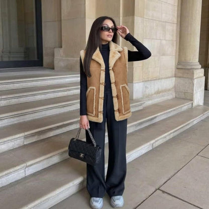 Woman wearing camel suede shearling-trim vest with sneakers